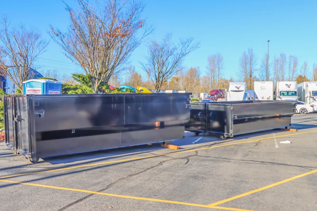 Professional dumpster rental service with roll-off container on residential driveway in Hazleton